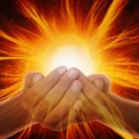 Hands cupped together with bright glowing energy radiating outward.